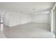 Bright open-plan living space with sleek tiled floors, neutral walls, and modern finishes at 4556 Windy Oak Way, St Cloud, FL 34772