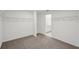 Walk-in closet space leading to bathroom with neutral carpeting and white walls at 4556 Windy Oak Way, St Cloud, FL 34772