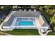 Aerial view of the community pool surrounded by lounge chairs and a covered walkway providing shade and comfort at 4638 Destrehan, Leesburg, FL 34748