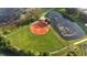 Aerial view of a lush community baseball field with a scenic pond, creating a serene recreation space at 4638 Destrehan, Leesburg, FL 34748