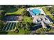 Aerial view showcasing community amenities: pool, clubhouse, tennis and pickleball courts, and well-maintained landscaping at 4638 Destrehan, Leesburg, FL 34748