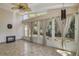 Light-filled sunroom featuring neutral colors, many windows, tile flooring, and a ceiling fan at 4638 Destrehan, Leesburg, FL 34748