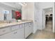 Bathroom featuring double sinks, granite countertops, tile flooring, and access to a walk-in closet at 5059 Lake Hamlin Trl, Winter Garden, FL 34787