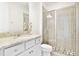 Bathroom featuring a glass-enclosed shower, granite vanity top, neutral tiling, and updated fixtures at 5059 Lake Hamlin Trl, Winter Garden, FL 34787