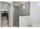 Modern bathroom featuring a glass-enclosed shower with gray tile and a view into the closet at 5059 Lake Hamlin Trl, Winter Garden, FL 34787