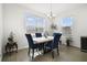 Cozy dining area featuring modern furniture, a stylish chandelier, and ample natural light at 5059 Lake Hamlin Trl, Winter Garden, FL 34787