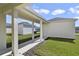 View of rear entryway with covered walkway and manicured garden at 5059 Lake Hamlin Trl, Winter Garden, FL 34787