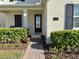 Charming front entrance with brick pathway, beautiful landscaping, and elegant address plaque at 5059 Lake Hamlin Trl, Winter Garden, FL 34787