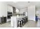 A bright kitchen featuring a large island with seating, stainless steel appliances, and modern finishes at 5059 Lake Hamlin Trl, Winter Garden, FL 34787