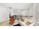 Upstairs living space featuring a sofa, chair, dark railing, recessed lighting, and neutral carpet at 5059 Lake Hamlin Trl, Winter Garden, FL 34787