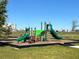 Community playground with slides and climbing structure on a beautiful day with a clear sky at 5059 Lake Hamlin Trl, Winter Garden, FL 34787