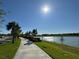 Scenic view of a pond from a community sidewalk on a sunny day at 5059 Lake Hamlin Trl, Winter Garden, FL 34787