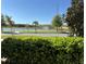 Scenic view of a pond framed by lush greenery and a clear blue sky at 5059 Lake Hamlin Trl, Winter Garden, FL 34787