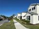 Street view of suburban homes with sidewalks and landscaped front yards on a sunny day at 5059 Lake Hamlin Trl, Winter Garden, FL 34787