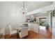Dining area connects to the kitchen, featuring a modern chandelier, tile floors, and access to the outdoor patio at 5417 Lake Margaret Dr # 39, Orlando, FL 32812