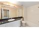 Well-lit bathroom boasts a tub/shower combo, toilet, and vanity with a spacious countertop and ample storage at 5512 Metrowest Blvd # 203, Orlando, FL 32811