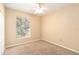 Bright bedroom with a window overlooking a tree-lined street at 5512 Metrowest Blvd # 203, Orlando, FL 32811