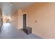 Hallway with a unit door and a wooden storage box, along with the stairs at 5512 Metrowest Blvd # 203, Orlando, FL 32811