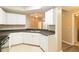 Kitchen with stainless steel sink and serving bar, looking into living area at 5512 Metrowest Blvd # 203, Orlando, FL 32811