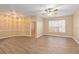 Sunlit living room featuring wood-look floors, neutral walls, and a ceiling fan for added comfort at 5512 Metrowest Blvd # 203, Orlando, FL 32811