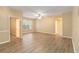 An airy living room featuring wood-look floors, a ceiling fan, and a large window, showcasing the neutral color palette at 5512 Metrowest Blvd # 203, Orlando, FL 32811