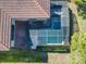 Aerial view of screened pool and house showcases the layout and backyard privacy at 5528 Solterra Cir, Davenport, FL 33837