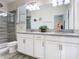 Bathroom featuring a double vanity, tiled shower, and modern fixtures at 5528 Solterra Cir, Davenport, FL 33837