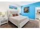 Comfortable bedroom with queen bed, side tables, and bright artwork at 5528 Solterra Cir, Davenport, FL 33837