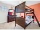 Cozy bedroom featuring a rustic wooden bunk bed, dresser with television, and nautical accents at 5528 Solterra Cir, Davenport, FL 33837