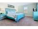 Inviting bedroom showcasing a blue bed frame, vibrant linens, and plenty of natural light at 5528 Solterra Cir, Davenport, FL 33837