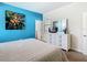 Cozy bedroom with bright blue accent wall and white furniture at 5528 Solterra Cir, Davenport, FL 33837