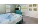 Charming bedroom featuring light green walls, matching blue furniture, and a comfortable-looking bed at 5528 Solterra Cir, Davenport, FL 33837