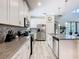 Bright kitchen with white cabinetry, stainless steel appliances, and modern tile backsplash at 5528 Solterra Cir, Davenport, FL 33837