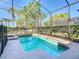 Inviting screened-in pool features lush landscaping and provides a private backyard oasis at 5528 Solterra Cir, Davenport, FL 33837