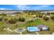 Aerial view of community pool, playground, and adjacent new home development, and open green spaces at 5733 Iron Brand Rd, St Cloud, FL 34771