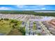 Expansive aerial view of a neighborhood with a central lake and lush greenery, showcasing community living at 5733 Iron Brand Rd, St Cloud, FL 34771