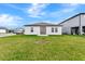 Beautiful backyard featuring lush green grass, modern home design, and spacious area at 5733 Iron Brand Rd, St Cloud, FL 34771