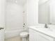 Bathroom featuring a tub and shower, with a sleek vanity and ample lighting at 5733 Iron Brand Rd, St Cloud, FL 34771