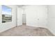 Well-lit bedroom featuring neutral carpet and two closets for storage at 5733 Iron Brand Rd, St Cloud, FL 34771