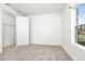 This is a small bedroom with neutral carpet and a window with a street view at 5733 Iron Brand Rd, St Cloud, FL 34771