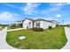 Well manicured lawn surrounding single Gathering home with a two-car garage, and inviting curb appeal at 5733 Iron Brand Rd, St Cloud, FL 34771