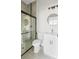 Bathroom featuring a glass shower, tiled walls with decorative accent, vanity with white countertop and round mirror at 6084 Sw 150Th Ln, Ocala, FL 34473