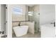 Bathroom features sleek tub, shower with glass door, and a vanity with black fixtures and quartz countertop at 6084 Sw 150Th Ln, Ocala, FL 34473