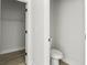 A toilet and a closet are visible in this small bathroom at 6084 Sw 150Th Ln, Ocala, FL 34473