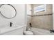 Modern bathroom featuring a tub-shower combination, new vanity, and a round mirror at 6084 Sw 150Th Ln, Ocala, FL 34473