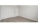 Neutral bedroom with light gray flooring, three door closet, and white baseboards throughout at 6084 Sw 150Th Ln, Ocala, FL 34473