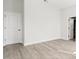 Bedroom with wood-look floors, white walls, and a door to the bathroom at 6084 Sw 150Th Ln, Ocala, FL 34473