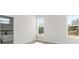 Bright bedroom featuring wood flooring, windows with natural light, and bathroom view through open doorway at 6084 Sw 150Th Ln, Ocala, FL 34473
