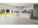 Open concept kitchen featuring stainless steel appliances, island, and sliding doors at 6084 Sw 150Th Ln, Ocala, FL 34473