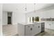 Bright kitchen features a large island, modern appliances, and sliding glass doors to the backyard at 6084 Sw 150Th Ln, Ocala, FL 34473